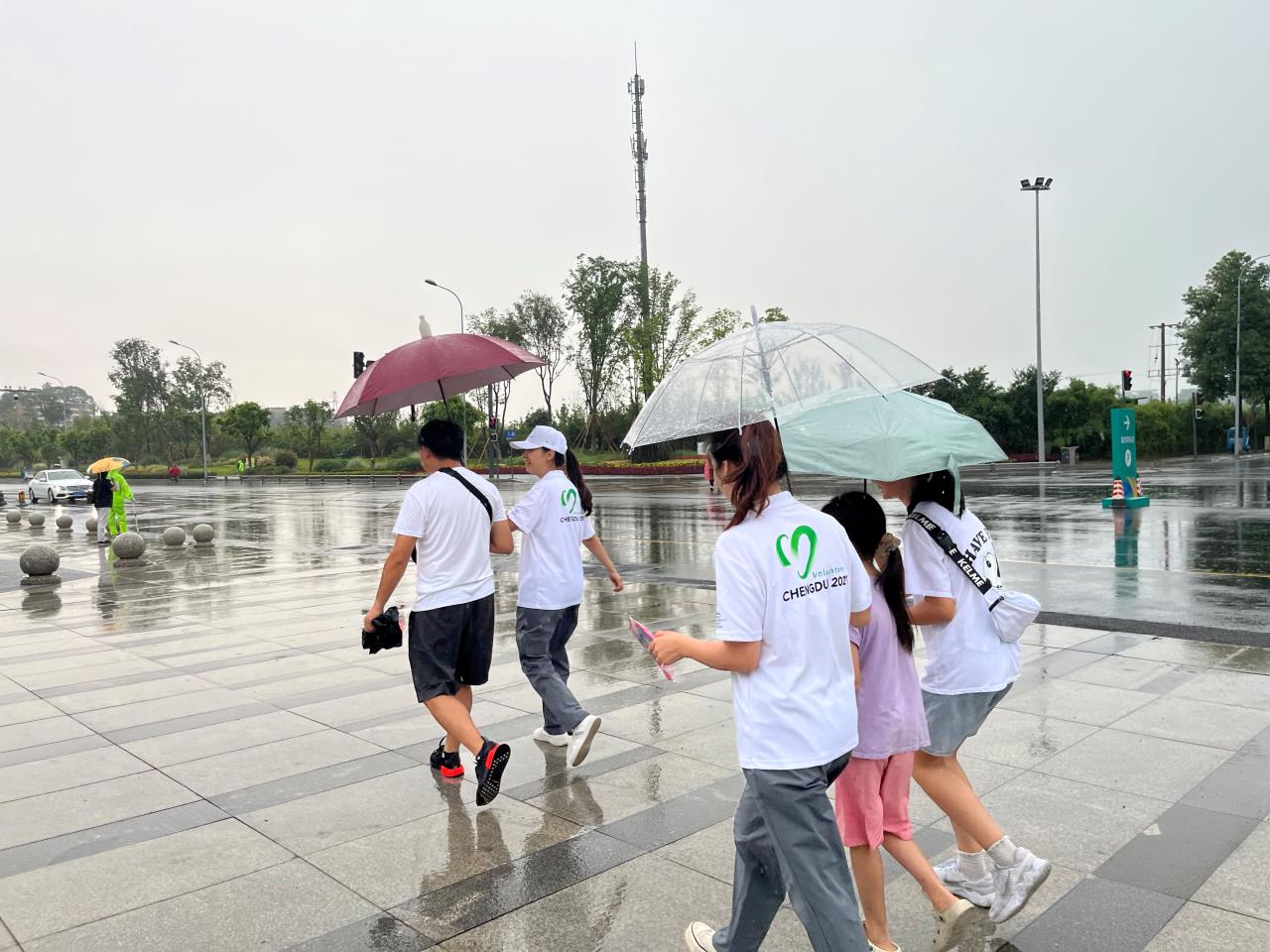 下雨天，志愿者们为没带伞的人打伞、接送