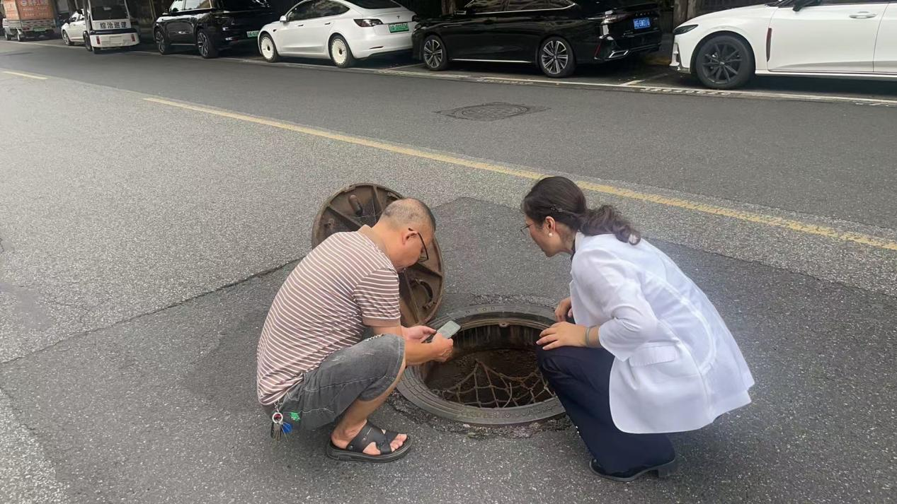 张静河长检查新桥逸景A区与金韵酒店之间的雨水井（新桥社区供图）